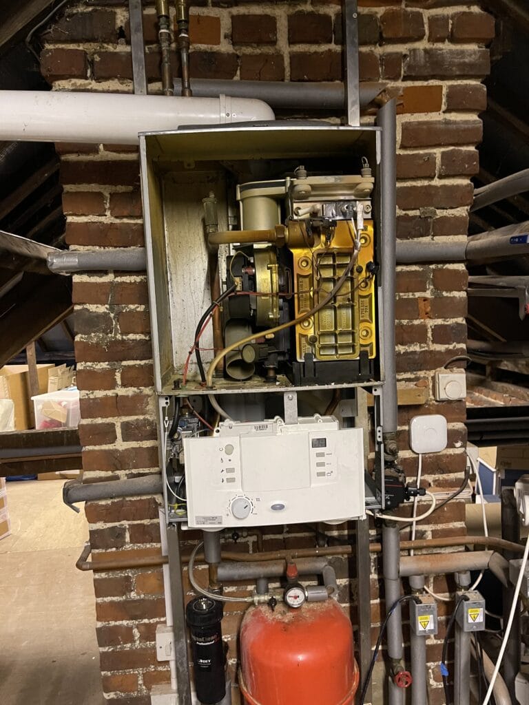 Gas boiler service in Norwich with boiler casing removed for inspection and maintenance