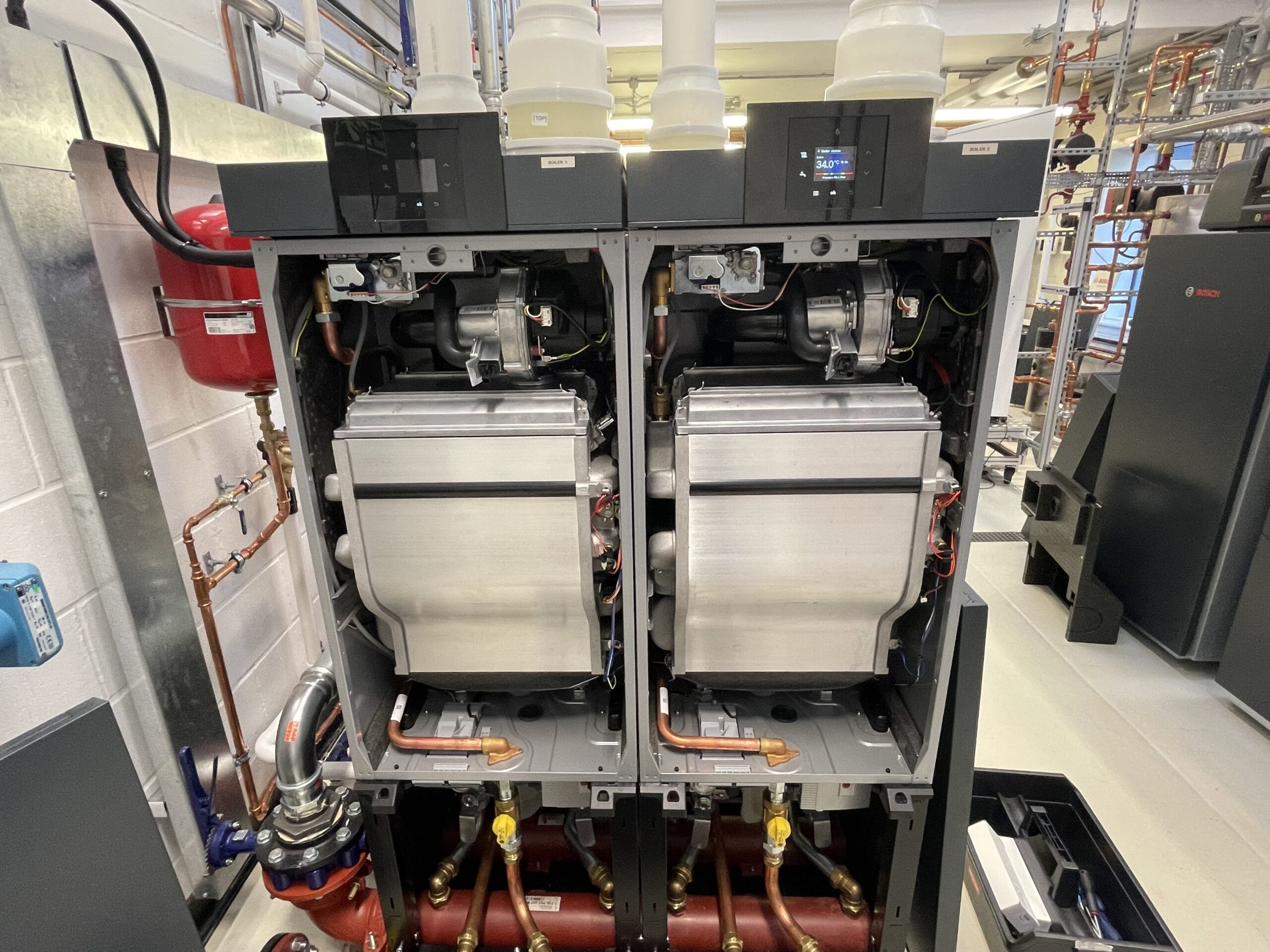 Commercial boiler service in Norwich with twin boilers opened for inspection and maintenance