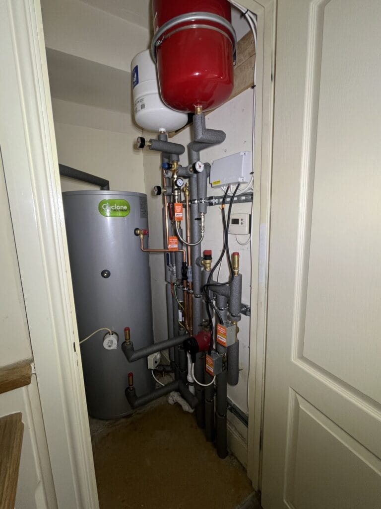 Unvented hot water cylinder installation in Norwich with expansion vessels, controls and insulated pipework