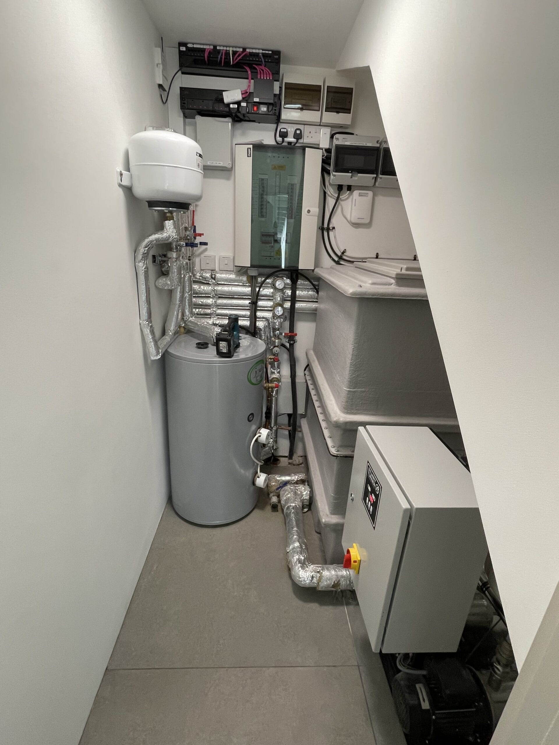 Commercial hot water & cold water system installation in Norwich with cylinder, booster equipment and insulated pipework