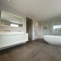 Luxury master bathroom installation in Norfolk with freestanding bath, vanity unit and walk-in sho