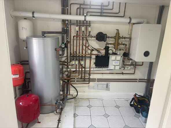 Radiator Upgrades and Smart Heating Controls for Poringland Family Homes | Allstar Systems Ltd Heating engineer checking radiators and smart controls in a Poringland family home
