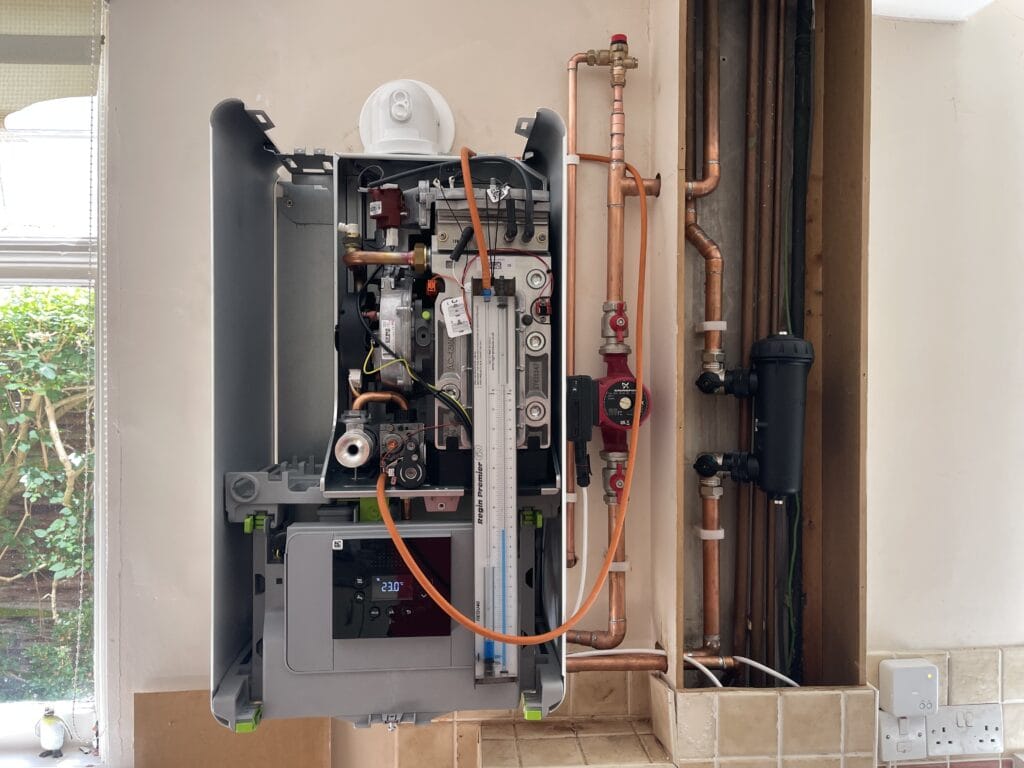 Engineer carrying out boiler servicing in a Coltishall village home