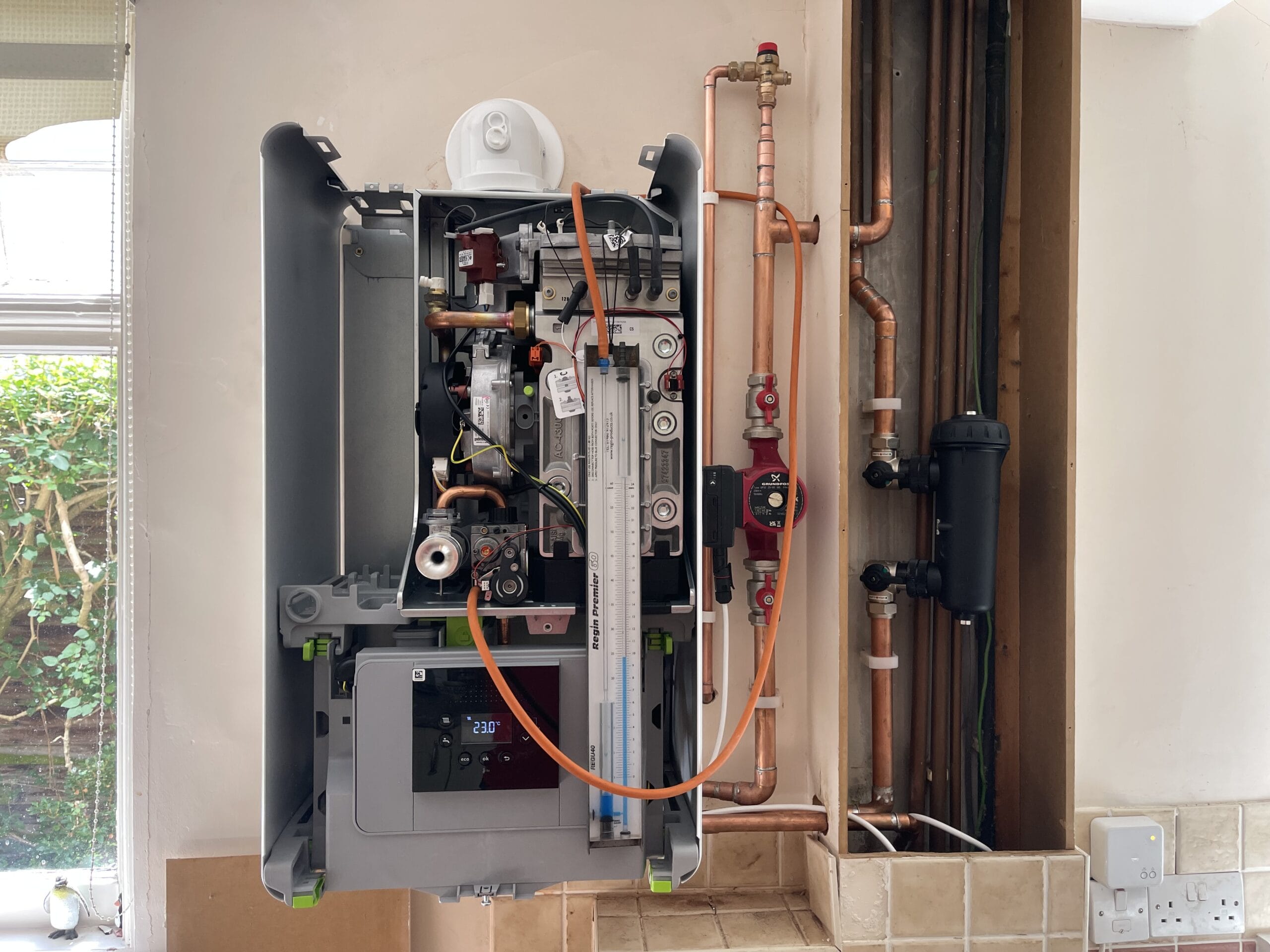 Engineer carrying out boiler servicing in a Coltishall village home