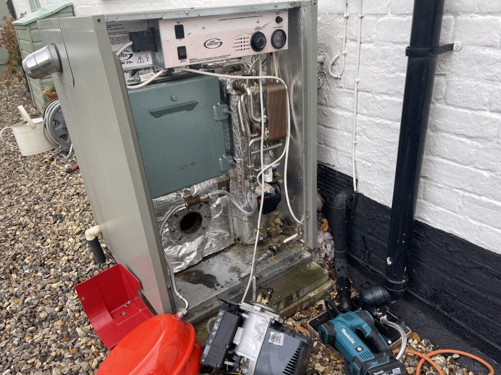 Oil boiler service in Norfolk with Grant Vortex oil boiler opened for inspection and maintenance