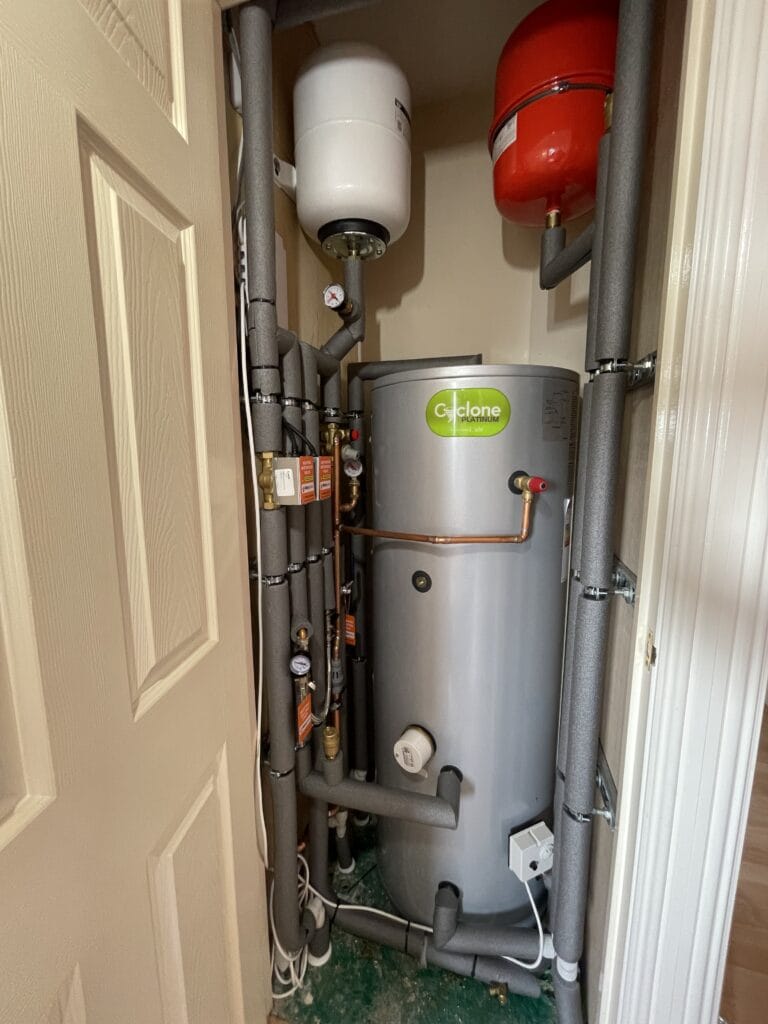 Planning Hot Water and Bathroom Demand for Growing Households in Long Stratton | Allstar Systems Ltd Plumber checking hot water and bathroom demand in a Long Stratton family home