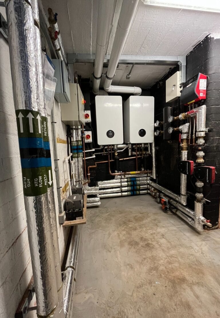 Commercial plumbing and heating engineer working at a managed premises in Poringland