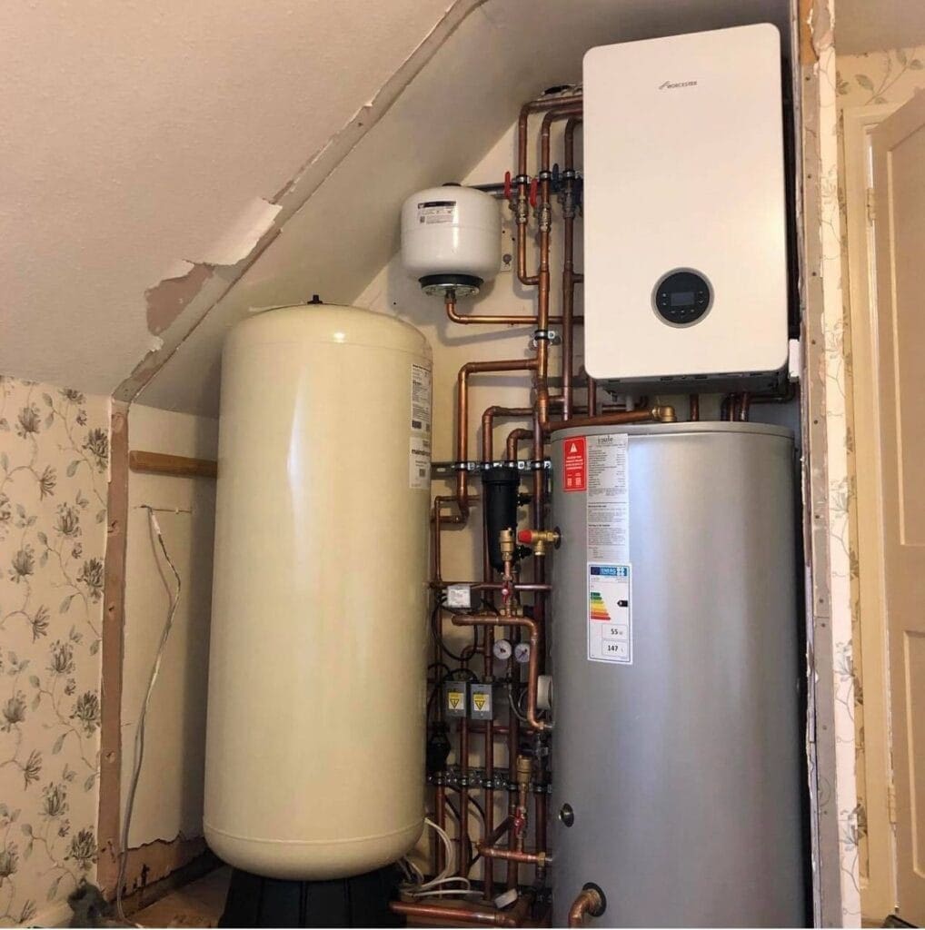 Worcester Bosch boiler with hot water cylinder, expansion vessel and copper pipework installed by plumbing and heating engineers in Norfolk