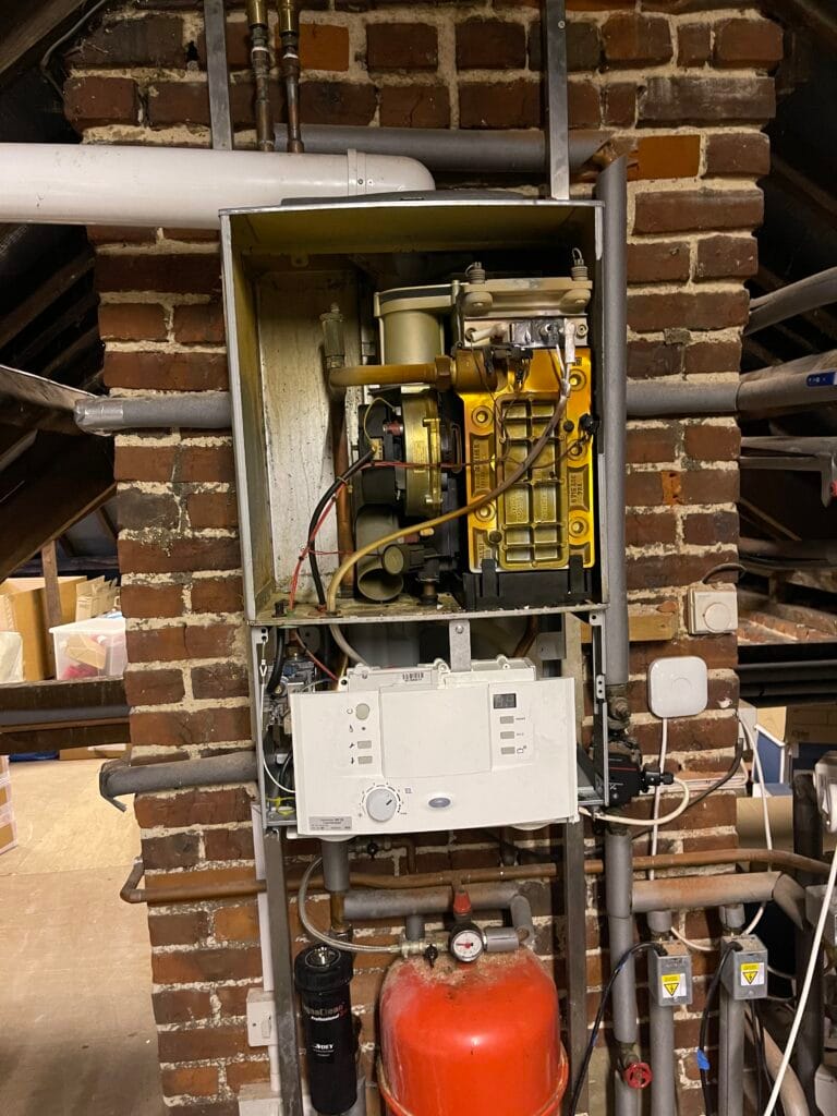 Gas Safe boiler service with casing removed, internal components exposed and heating system parts inspected