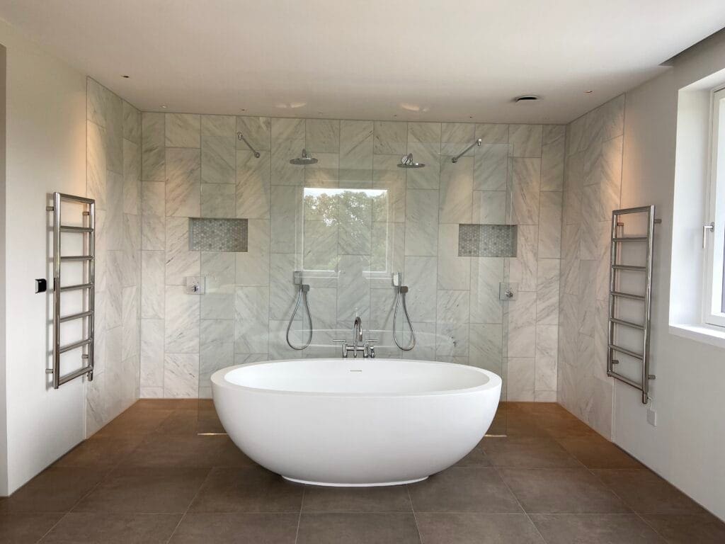 How to Plan Bathroom Layout and Hot Water Demand Together in Wymondham Homes | Allstar Systems Ltd Plumber assessing bathroom layout and hot water requirements in a Wymondham home