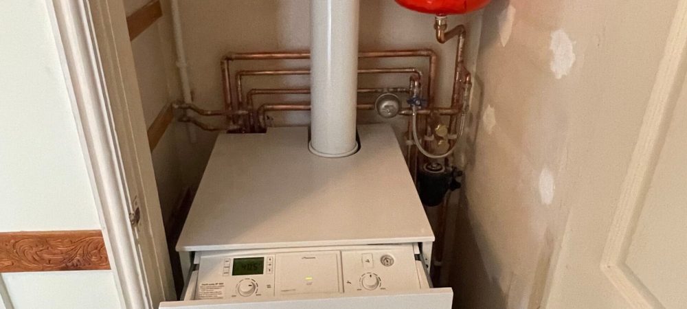 Heating engineer checking gas oil and LPG boiler options for an Aylsham home