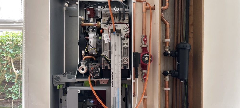 Engineer servicing a boiler for a holiday let or second home in Horning