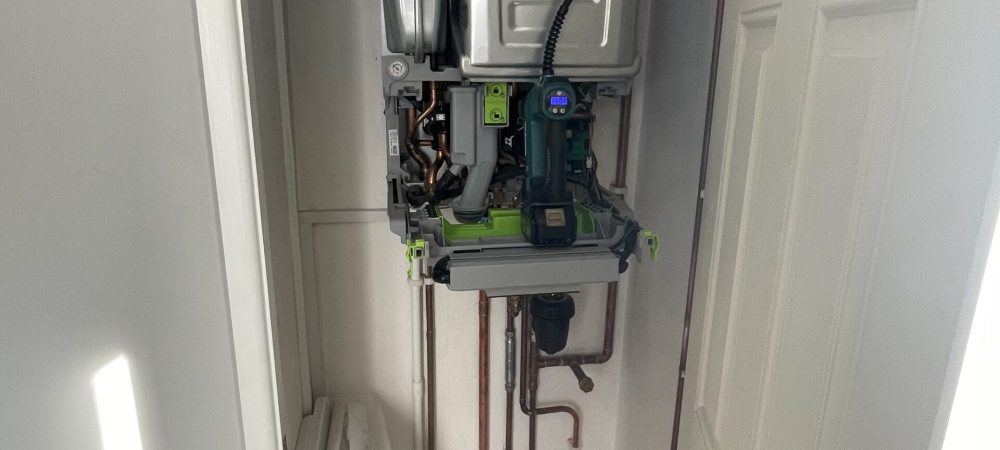 Heating engineer checking recurring boiler pressure loss in a Long Stratton home