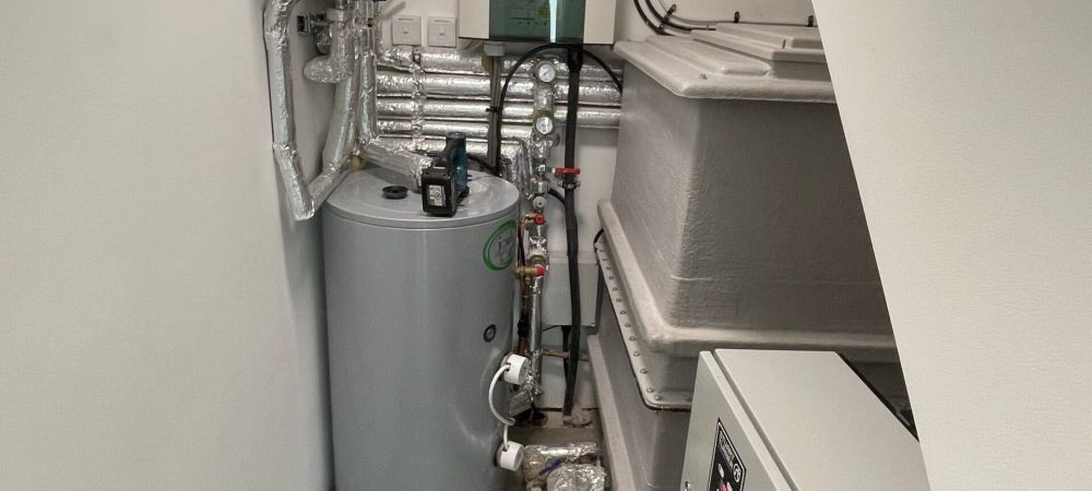 Plumber checking hot water flow and pressure at a home in Aylsham