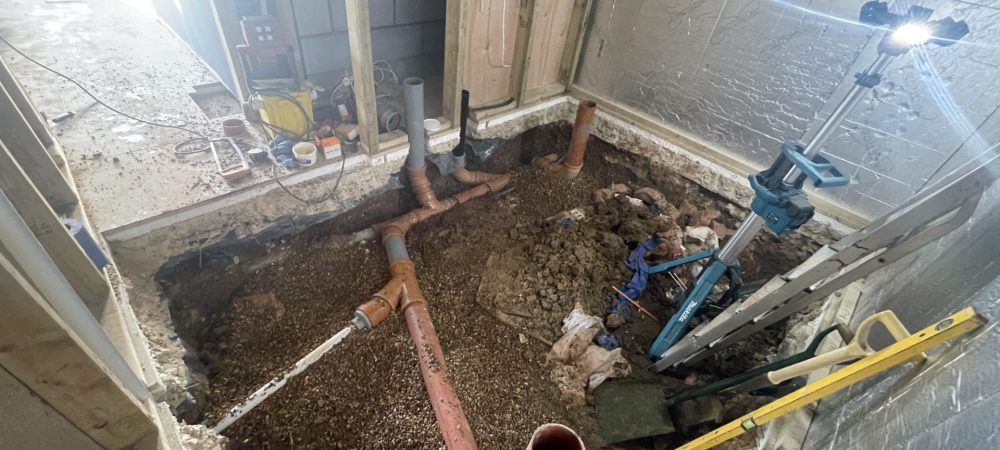 Plumber checking pipework to prevent leaks in a Coltishall home