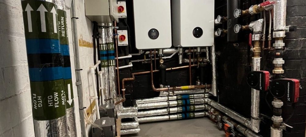 Commercial plumbing and heating engineer working at a Fakenham business premises