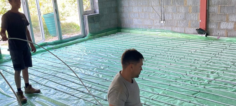 Heating engineer planning underfloor heating and smart controls in a North Walsham renovation