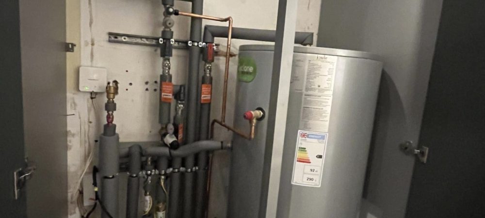 Heating engineer balancing radiators and checking controls in an older Holt home