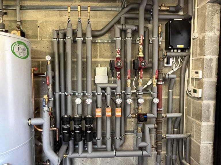 Commercial heating engineer carrying out planned maintenance at a Wymondham managed building