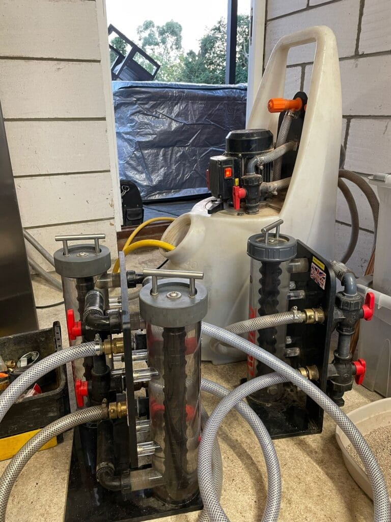 Heating engineer checking system cleaning before boiler replacement in a Mulbarton home