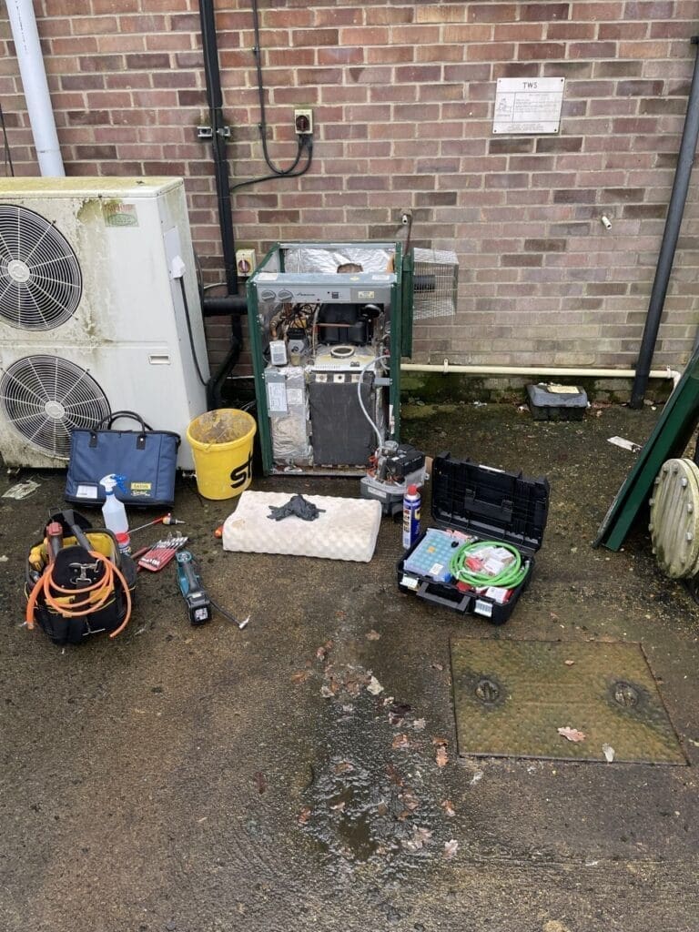 Heating engineer carrying out annual boiler servicing in a Fakenham home